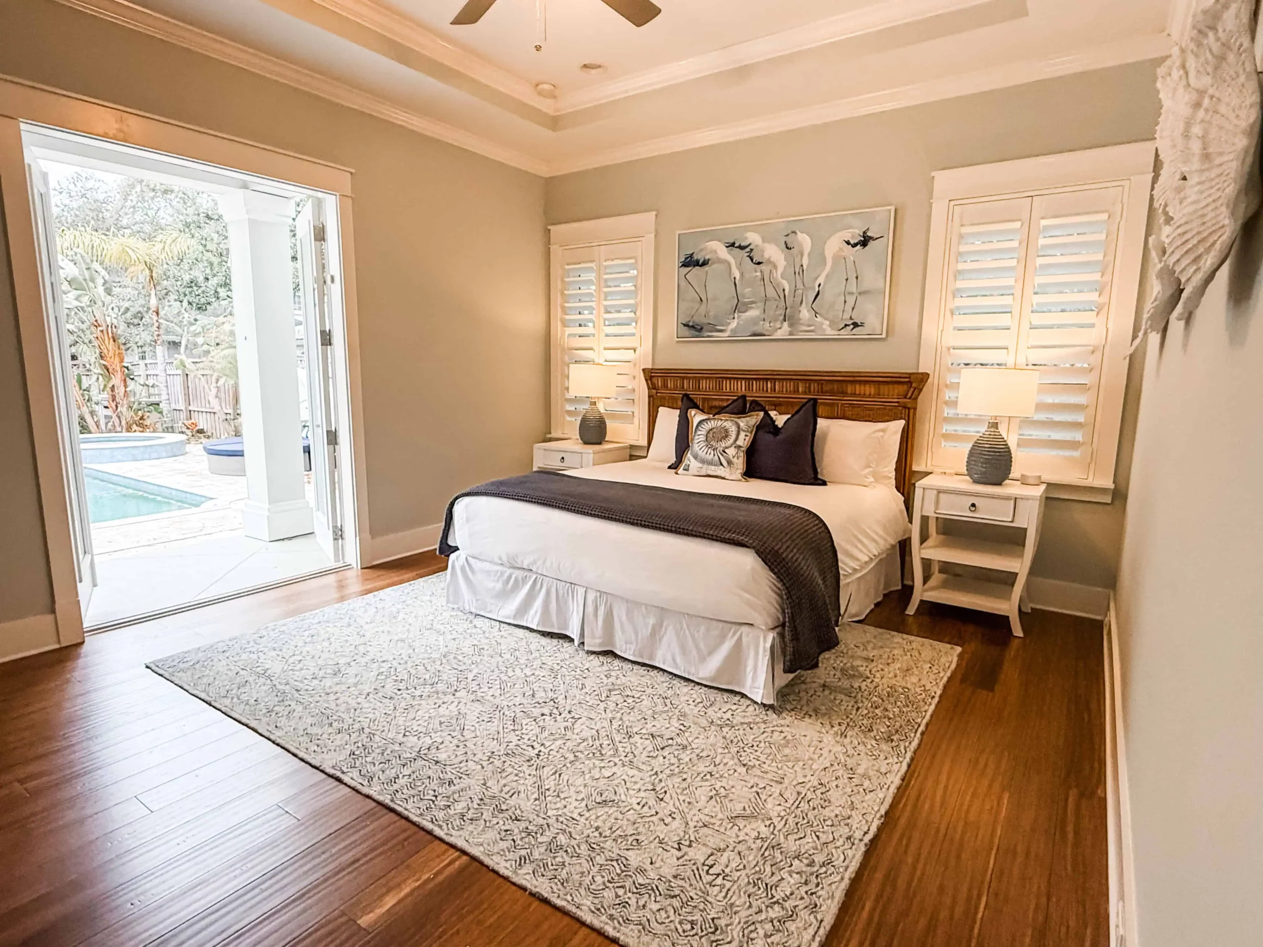 Private bedroom with a king bed, pool access, and coastal decor at a Luxe Couples Retreat property.