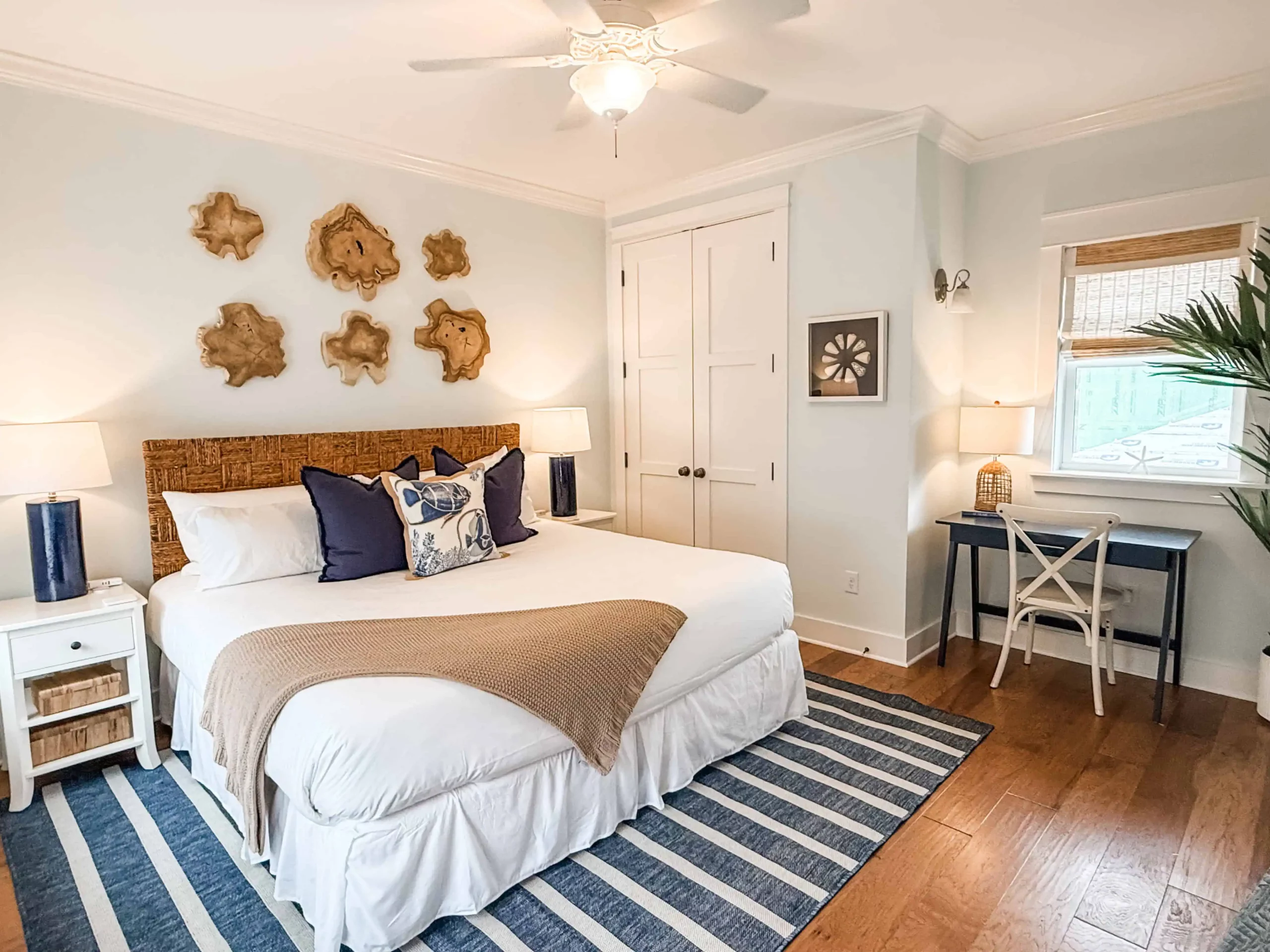 Coastal bedroom with a king bed, writing desk, and warm lighting at a Luxe Couples Retreat property.