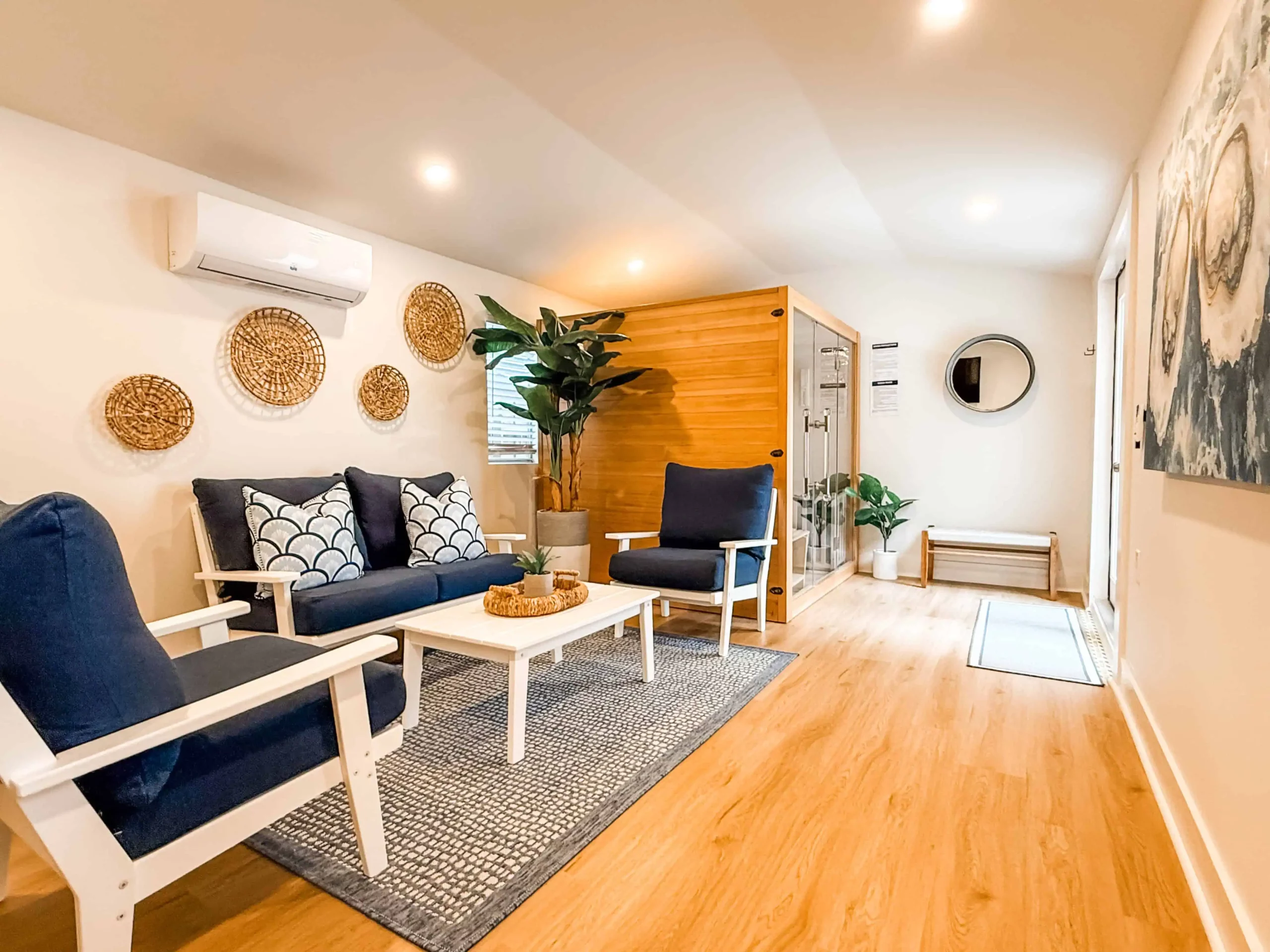 Spa lounge with seating, coastal decor, and a private sauna at a Luxe Couples Retreat property.